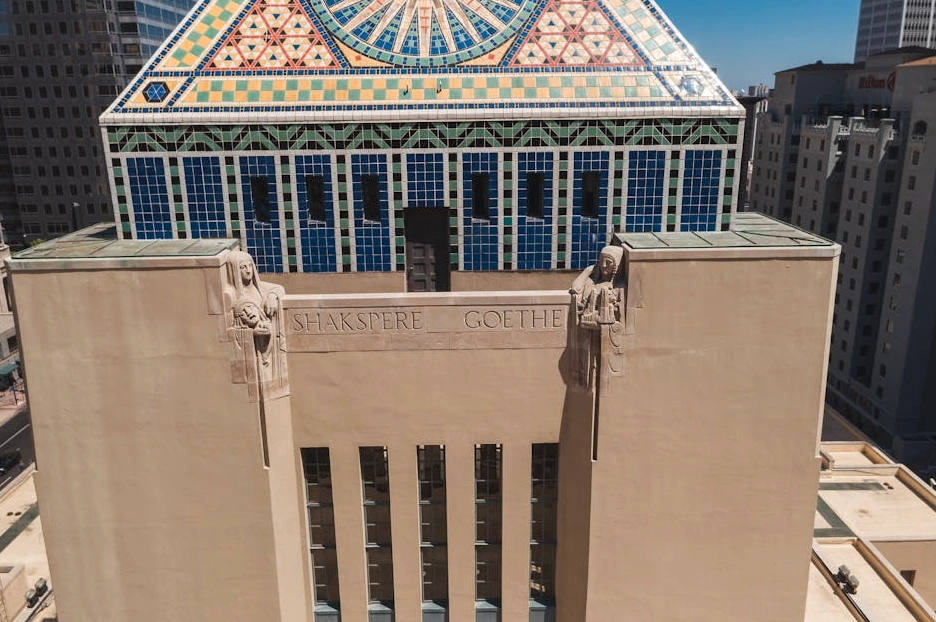 An expansive, modern library with large windows overlooking a diverse city skyline.